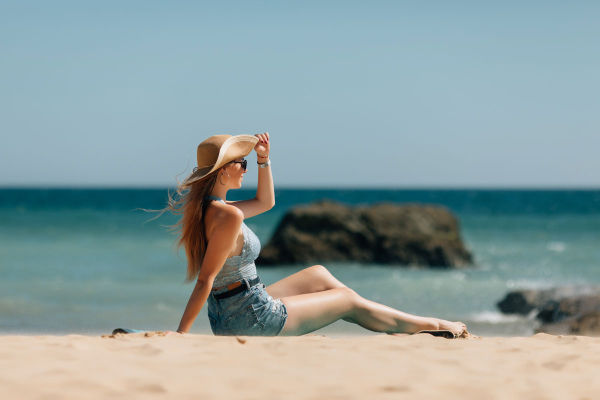 young-woman-sitting-sea-beach-1